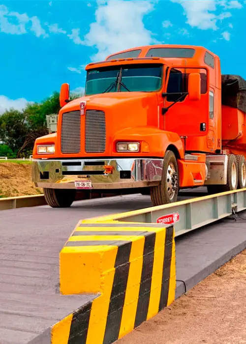 Camión de carga pesada sobre una báscula camionera de plataforma, diseñada para medir grandes pesos de manera precisa, utilizada en carreteras y centros de distribución para garantizar el cumplimiento de las regulaciones de peso.